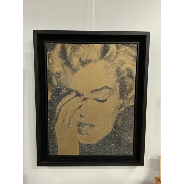 Framed painting by Russell Young depicting Marilyn Monroe in a striking emotional portrait. Features signature...
