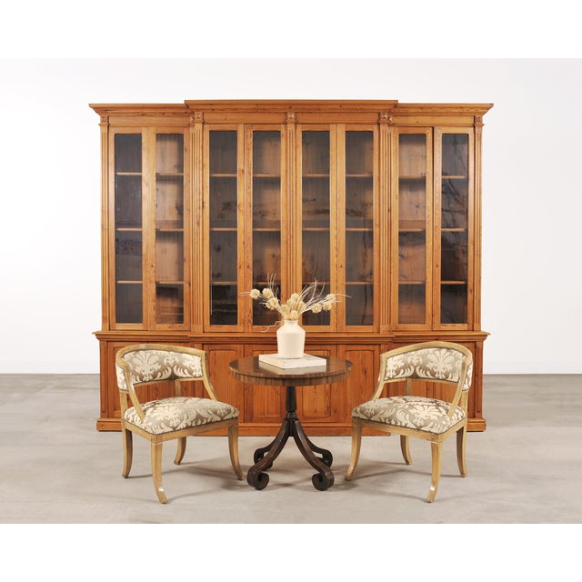 A monumental early 20th century French Provincial-style two-piece breakfront pine library bibliotheque bookcase cabinet...