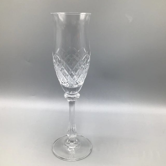 Mikasa Diamond cut crystal champagne flutes with bell style bowl and fluted stem. The bowl mouth measures 2 1/8 inches...