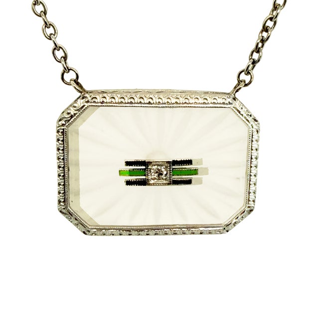 A beautifully detailed Art Deco pendant necklace featuring carved rock crystal, 10K/14K white gold, and enamel accents....