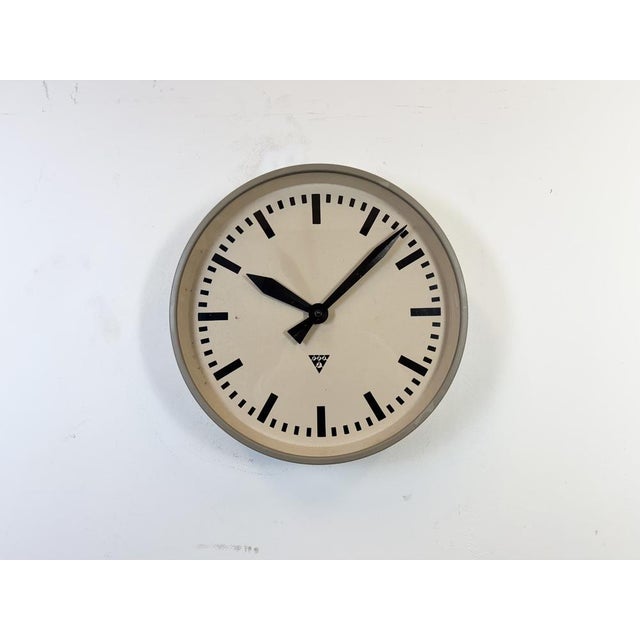 Pragotron wall clock made in former Czechoslovakia during the 1960s. It features a brown metal body, a metal dial and a...