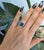 A generous 4.01-carat London blue topaz glows in deep, oceanic blue at the centre of this solid 10K yellow gold estate...