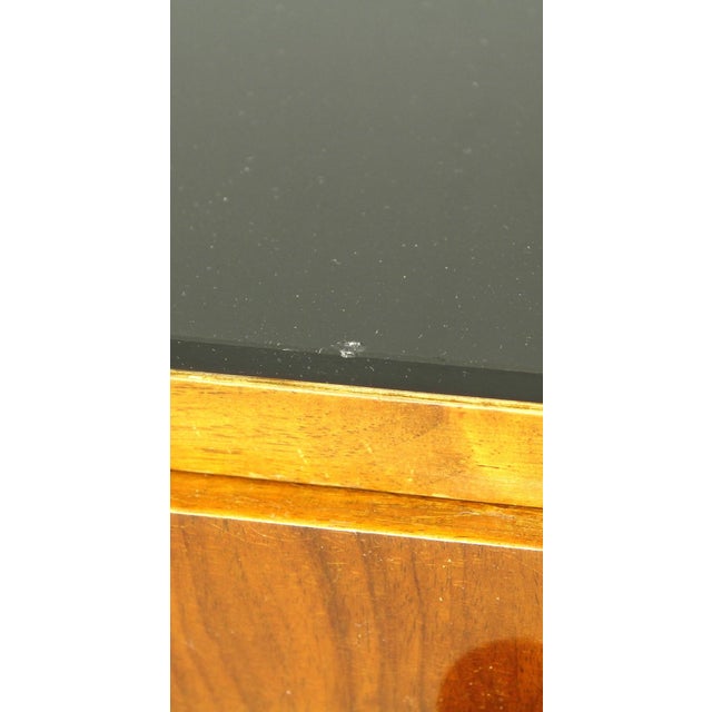 A pair of Czech bedside tables with black opal glass tops. Very high-quality factory workmanship. Veneered with walnut...