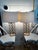 Beautiful pair of metallic gold quatrefoil table lamps. The lamp finish is a soft gold metallic and drum shade is in ivory...