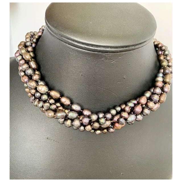 Gorgeous five strand peacock freshwater pearl necklace. Very versatile, accented with round, oval and different shapes of...