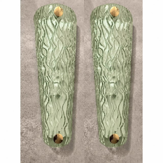 Impressive wall sconce made in clear graniglia of Murano glass. Made with a traditional Murano glass slab processing...