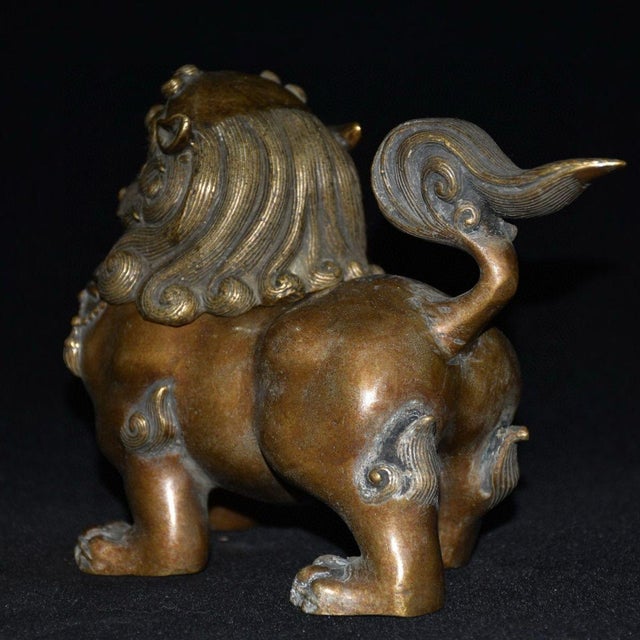 This finely cast bronze guardian lion incense burner features a unique design with a removable head that reveals a hollow...