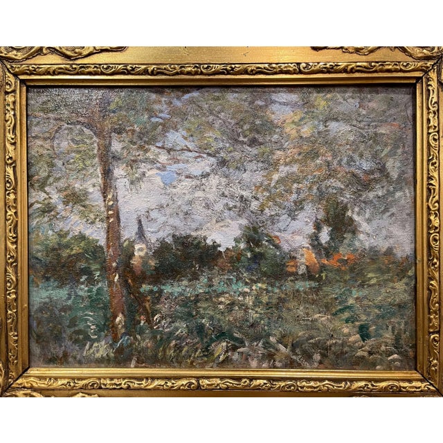 Evoking the quiet beauty of the French countryside, this antique oil painting presents a pastoral landscape with a village...