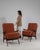 Here is a lounge chair, its dark wood angled frame, rust/terracotta upholstery the first thing to catch the eye. Dating to...
