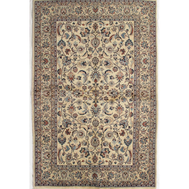 Antique hand-knotted Persian Mashad wool rug with an ivory field featuring a refined allover floral pattern of scrolling...