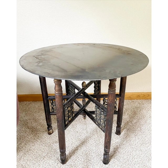 Industrial Moroccan Side Table With Round Raw Steel Top + Weathered Folding Base For Sale - Image 4 of 16