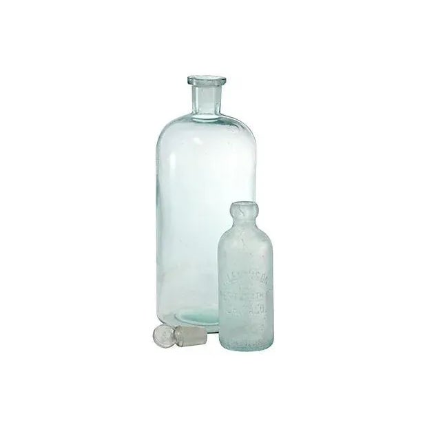 Pair of antique aqua blue heavy glass apothecary jars, circa 1880. Large bottle with glass stopper measures 4.5”W x 13”H...