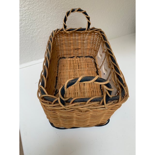 Rustic whimsical wood basket with side handles and decorative ceramic tile inserts with a rooster strutting in the sunshine.