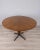 Round table with black metal frame and gold-plated brass feet, veneered wood top, designed by Carlo Ratti for Lissoni,...