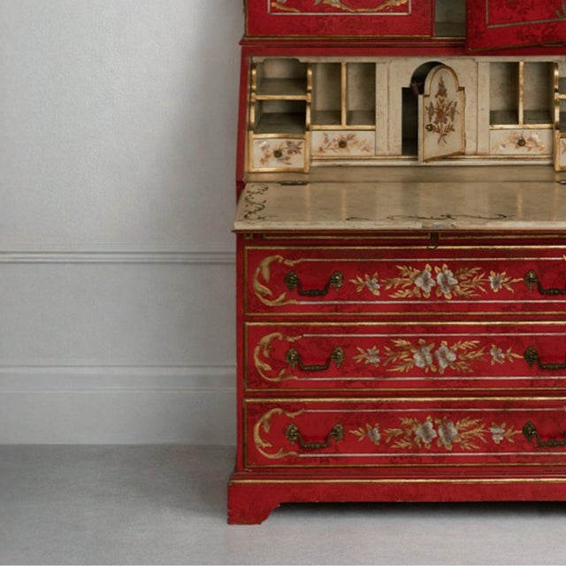 This Chinoiserie bureau bookcase features three long drawers at the bottom, a cabinet at the top with several shelves, and...