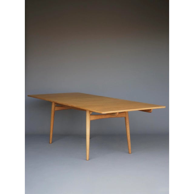 A dining table, model at 310 designed by hans wegner in 1955. legs in solid oak ,table top in oak veneer. A classic piece...