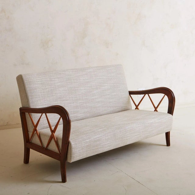A vintage Italian wood frame settee in the style of Paolo Buffa. This piece has beautiful curved maple wood arms with...