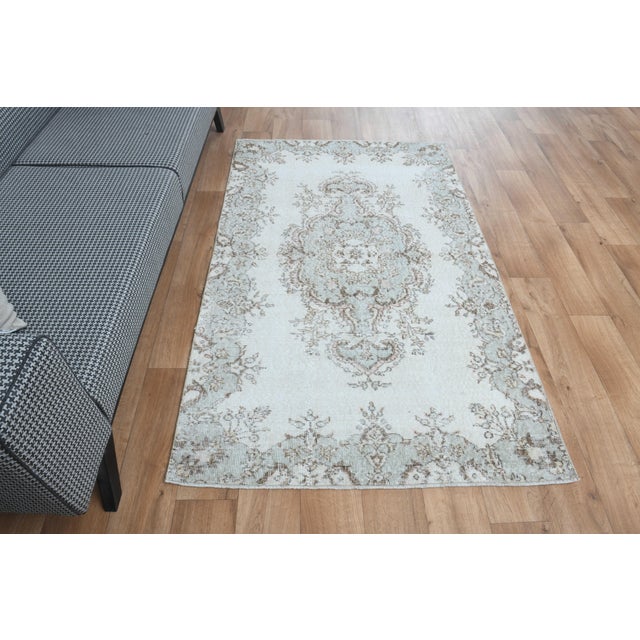 This vintage hand-knotted area rug is a semi-antique vintage area rug. The '70s Eastern region of Anatolian's unique rug...