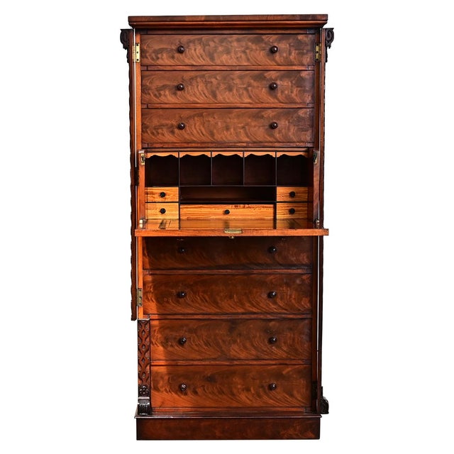 English circa 1820 Wellington-style chest of drawers made of mahogany in dazzling flamed grain that stretches across the...