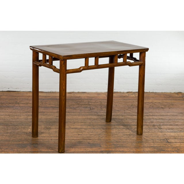 A 1900s Chinese Antique Wine Console Table made with elmwood. Emanating an aura of rich history blended with an impeccable...