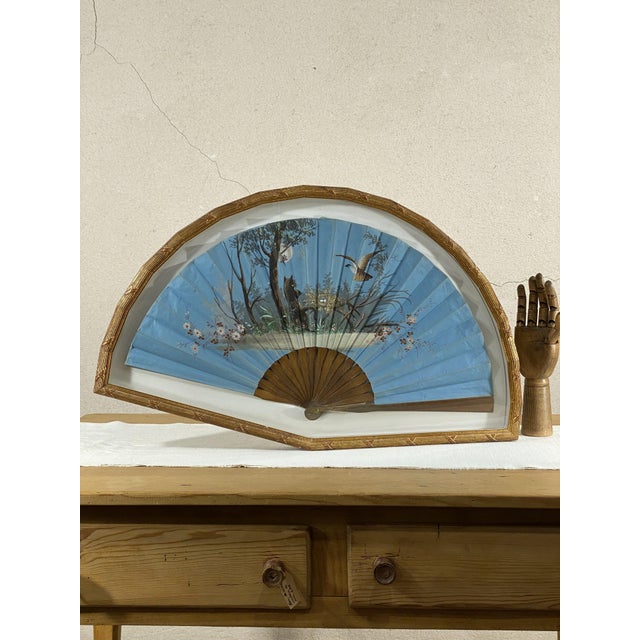 Fan with hand-painted fabric country representing a scene in which a bird of prey takes care of its eggs threatened by a...