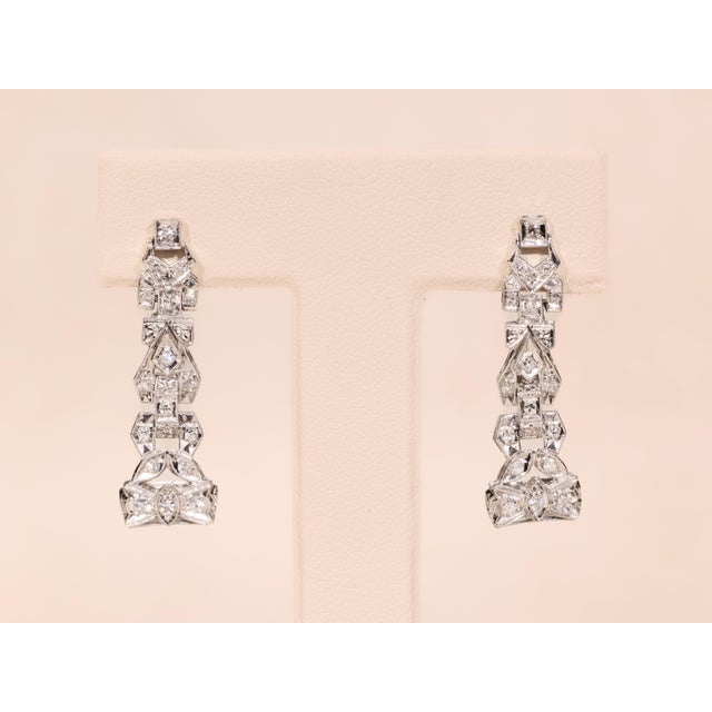 The Davinas Ladies Antique Platinum and Diamond Dangler Earrings. These delicate danglers are crafted in durable platinum...