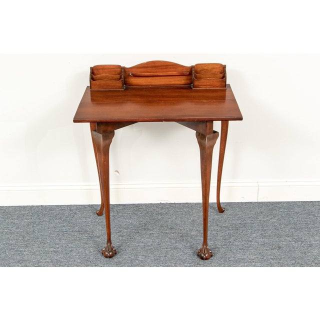 An antique mahogany writing desk or vanity with a raised gallery top with multiple letter compartments, lift-top or hinged...