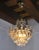 Very nice little hollywood regency chandelier dating from the 70s. This chandelier is composed of carved rocca crystals...