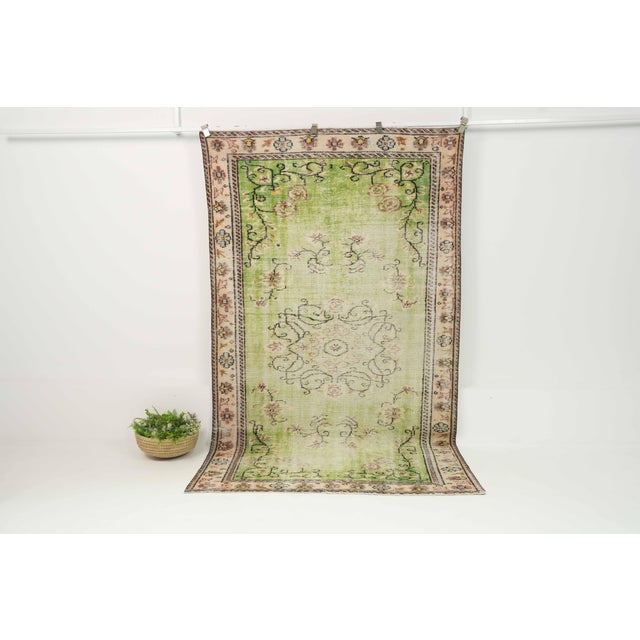 This vintage hand-knotted area rug is a semi-antique vintage area rug. The '70s Eastern Anatolian region's unique rug is...