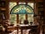 A spectacular antique architectural stained glass window featuring an arched form, richly colored leaded glass and a...