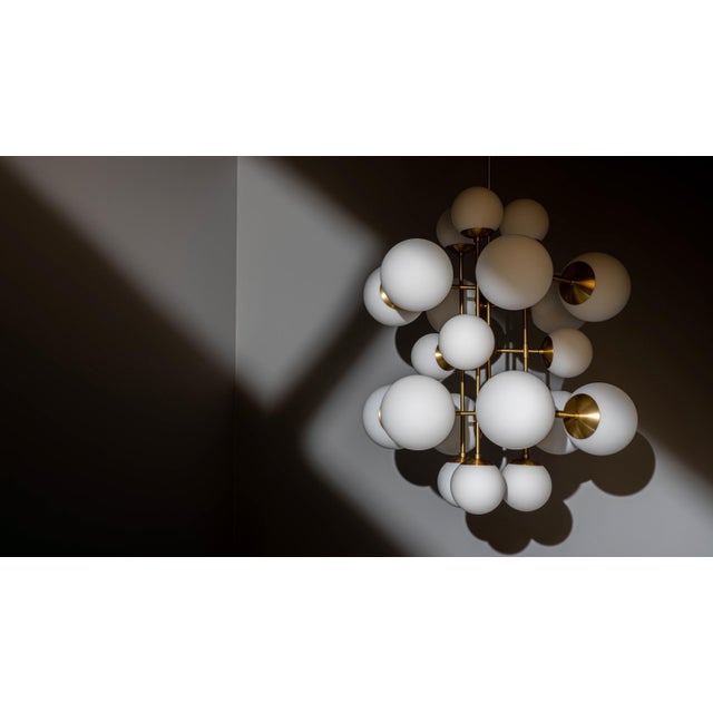 Offered by Schwung A kaleidoscope of glass spheres perambulates around a linear brass frame. Made with two sizes of glass...