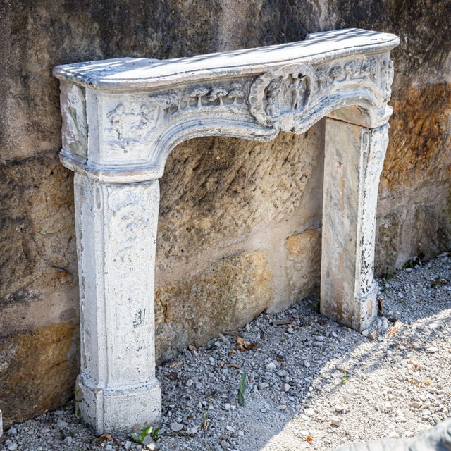 Decorative fireplace surround made of white-glazed terracotta, crafted in the 19th century in the Baroque style. Featuring...