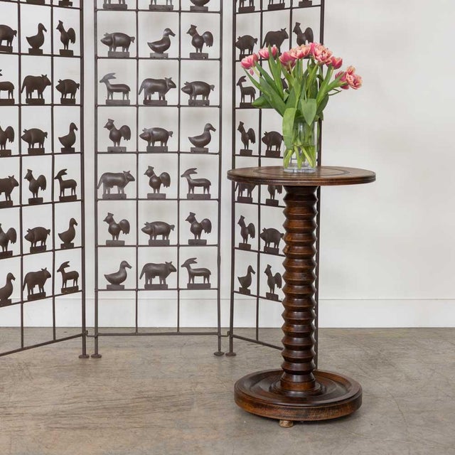 Beautiful carved wood table by Charles Dudouyt, made in France, 1940s. Thick carved wood stem with circular top and base....