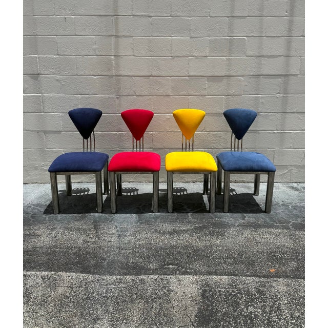 A vibrant and sculptural set of four postmodern dining chairs in richly upholstered suede with polished chrome bases....