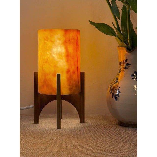 Comet pairs a hand-carved Egyptian alabaster shade with a geometric walnut base, combining contemporary form with...