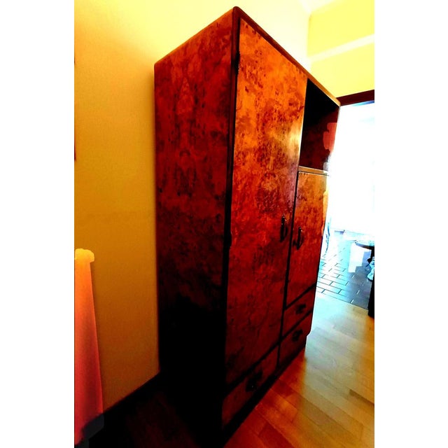 An original 1930s Italian birch burl wardrobe, exceptionally well-preserved and part of a bedroom, which has survived to...