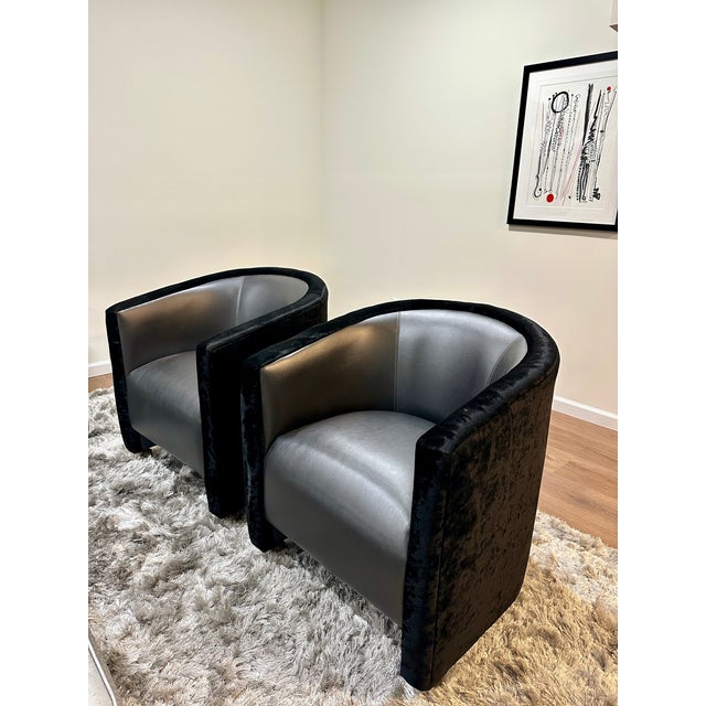 Spotless pair of vintage club chairs made by the brand Carson's Hospitality. Black vinyl seats with black velvet backs. In...