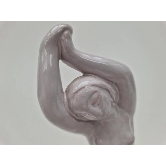 Beautiful set consisting of a figure and two matching candle holders, all parts of Hjorth, Denmark around 1960. This piece...