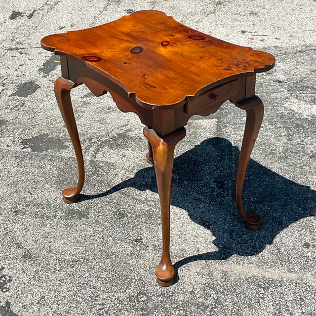 This vintage side table embodies timeless American style with its traditional knotty pine construction. Its rustic charm...