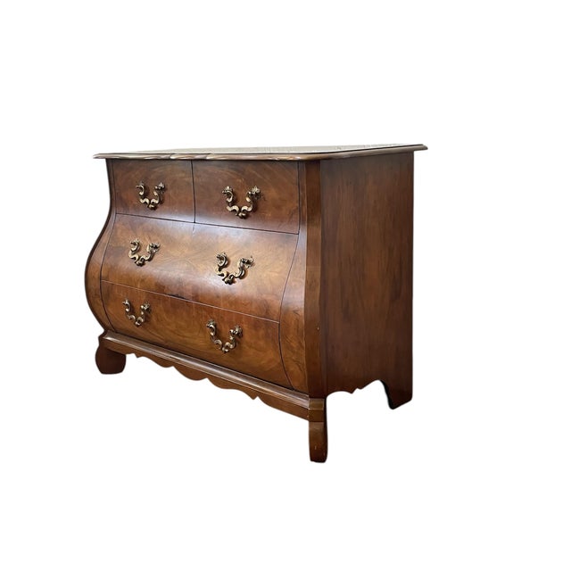 Baker Furniture Collector Bombe-Front Commode. An extraordinary four-drawer commode crafted from richly figured walnut,...