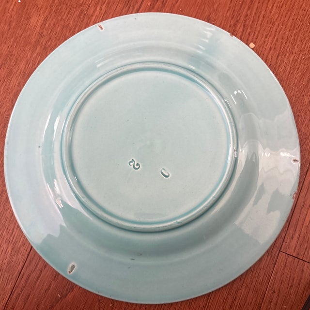 This is a decorative ceramic plate, specifically a piece of antique French Barbotine Majolica pottery, likely dating from...