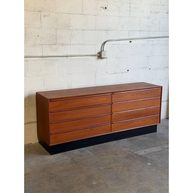 This minimalist lowboy profile offers substantial storage space across eight spacious compartments. Clean geometric lines...