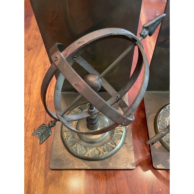 Vintage Brass Armillary Sphere & Arrow Bookends. An armillary sphere is a model of the celestial globe constructed from...