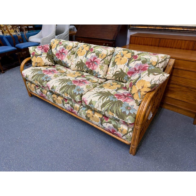 Contemporary Lane Venture rattan floral sunroom sofa. It seats three and the upholstery is original. Excellent vintage...