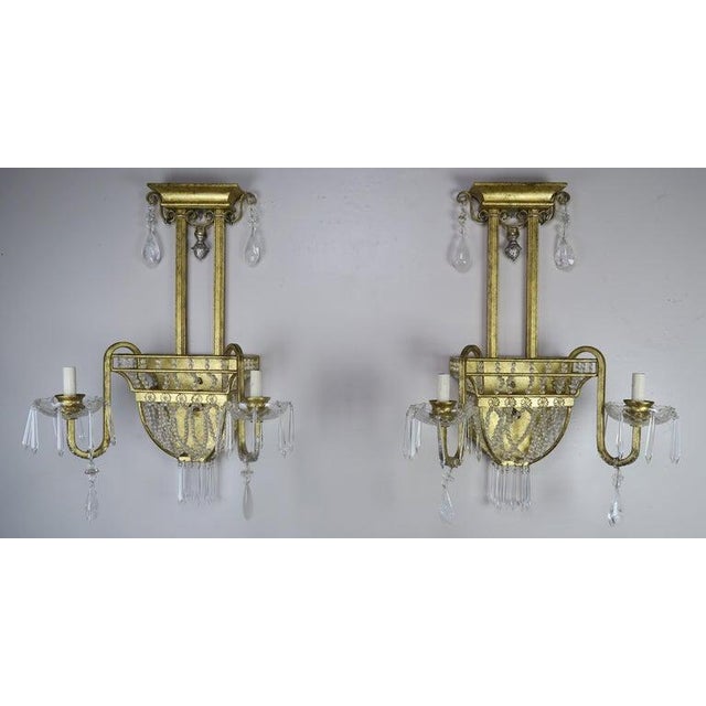 Pair of early 20th century 2-light cast bronze and rock crystal sconces. The sconces are detailed with strands of tiny...