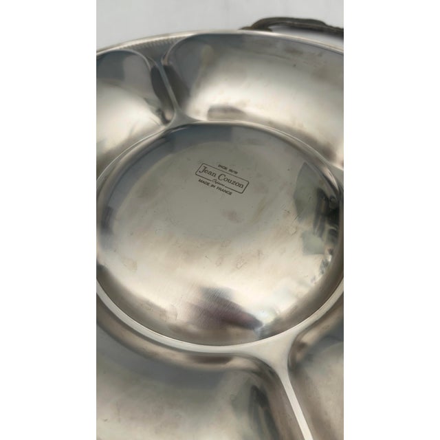 Large round stainless steel tray with compartments, designed by Jean Couzon, made in France, an iconic example of...