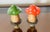 Cute pair of small mushroom figurines on brass bases as lamp finials.