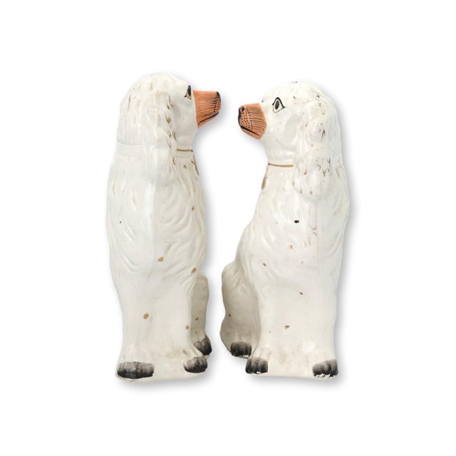 Large antique English Staffordshire King Charles spaniel dogs featuring a traditional seated form with hand-painted...