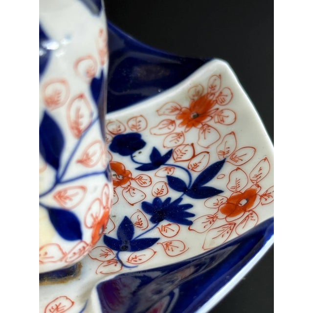 This elegant inkwell is a fine example of Meiji-period Imari porcelain, richly decorated in underglaze cobalt blue, iron...