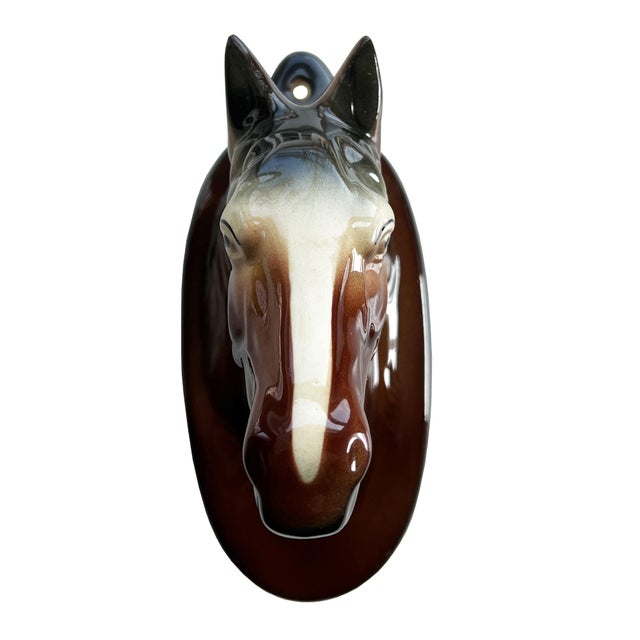 A sculptural vintage ceramic wall vase in the form of a bridled horse head, finished in a rich hand-glazed palette of...